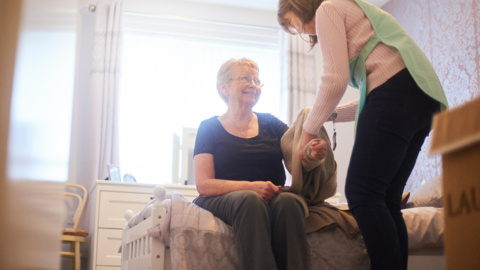 Caregiver helping woman